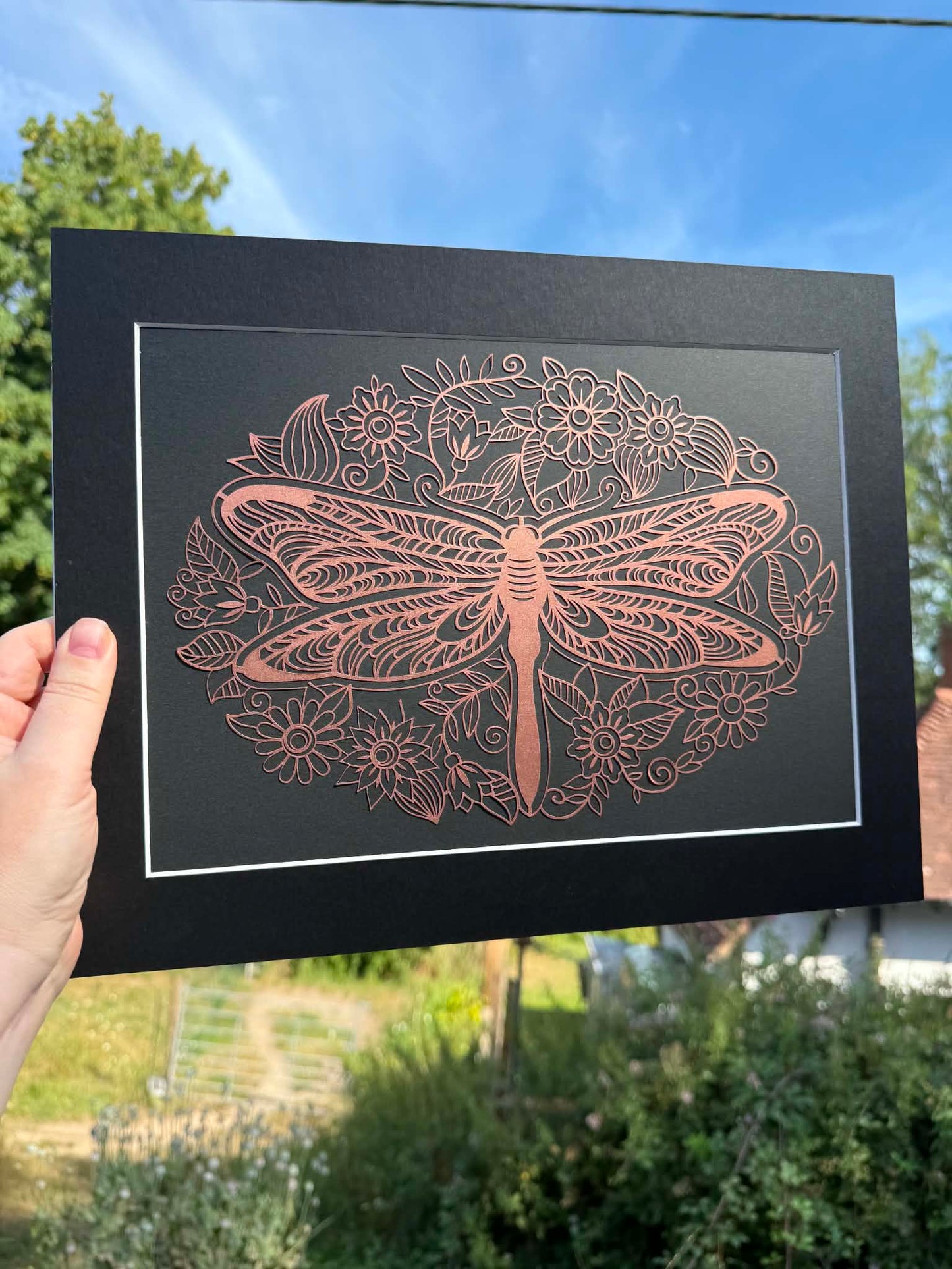 Bronze ornate dragonfly papercut.