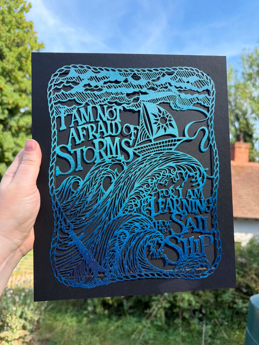 Gorgeous blue airbrushed sparkly Storm papercut.